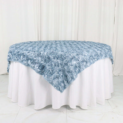 Blue rose-patterned tablecloth draped over a white table.