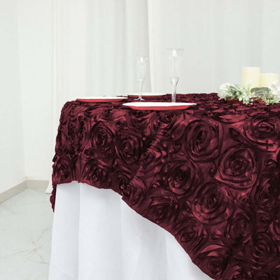 Burgundy rose-patterned tablecloth draped elegantly over a table.