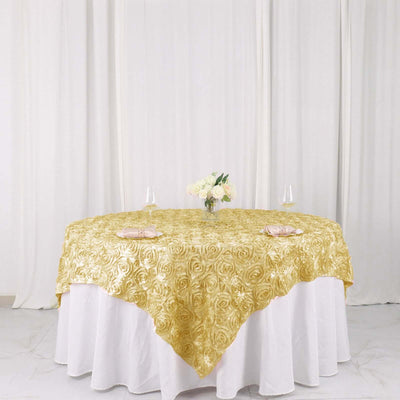 Gold rose-pattern tablecloth on a round table with floral centerpiece.