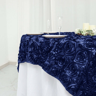 Navy rose-patterned tablecloth draped over a table with elegant glassware.