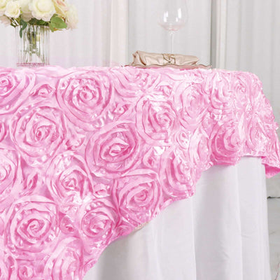 Pink rose-patterned tablecloth draping elegantly over a white table.