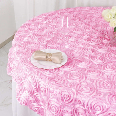 Pink rose petal tablecloth with a napkin and plate set for an elegant dining experience.
