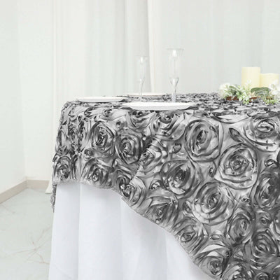 Gray rose-patterned tablecloth draping elegantly over a table setting.