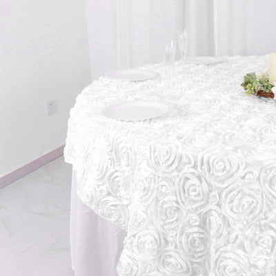White rose-patterned tablecloth on a round table.