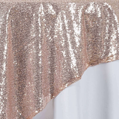 Rose gold sequin tablecloth draped elegantly on a table.