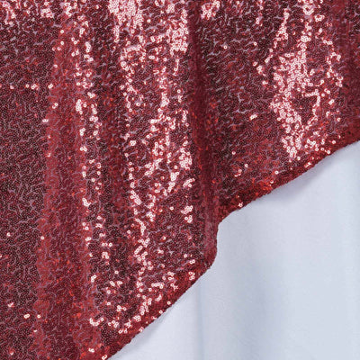 Red sequin fabric with a shimmering texture.