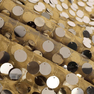 Gold sequin fabric with circular metallic discs on a mesh background.