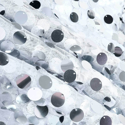 Silver sequin fabric with circular reflective discs.