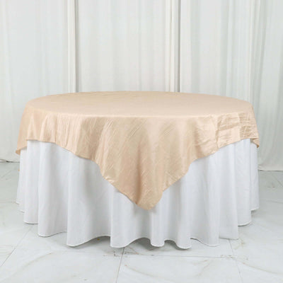 Round table with beige satin tablecloth on white table skirt