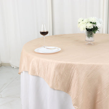 Create a Luxurious Dining Experience with our Beige Accordion Crinkle Taffeta Table Overlay