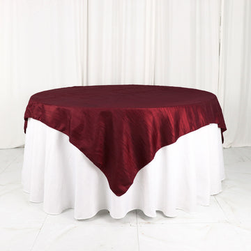 Elevate Your Event with the Burgundy Accordion Crinkle Taffeta Table Overlay