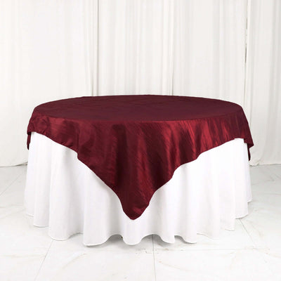 Burgundy tablecloth draped elegantly over a round table
