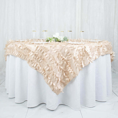 Elegant beige tablecloth with leaf details draped over a round table.