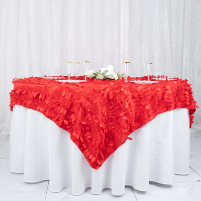 Red tablecloth with textured petals draping over a white table.