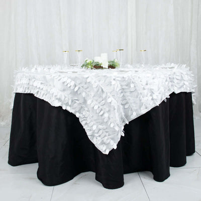 Elegant white tablecloth with leaf details on a black table.