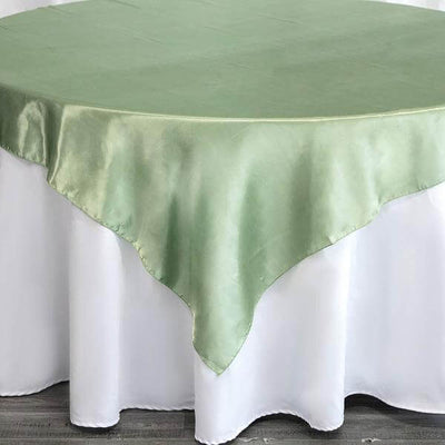 Green satin tablecloth on a white table.