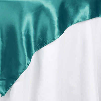 Teal satin fabric draped over white fabric
