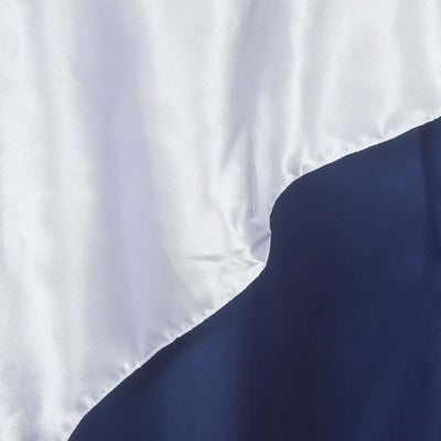 Silky fabric in white and navy blue with smooth drape detail.