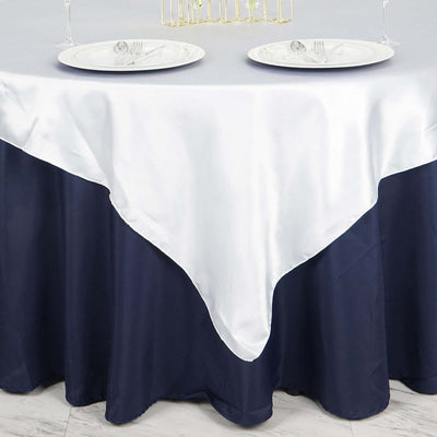 Elegant navy and white tablecloth draping over a round table.