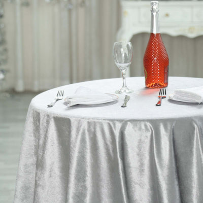 Elegant silver tablecloth set for a dining experience with champagne and glass.