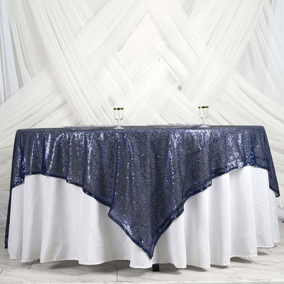 Navy blue sequin tablecloth draped elegantly over a white table.
