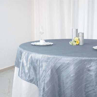 Elegant gray tablecloth draped on a round table with decorative items.