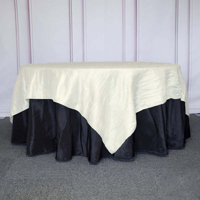 Elegant cream and black tablecloth draped over a round table.