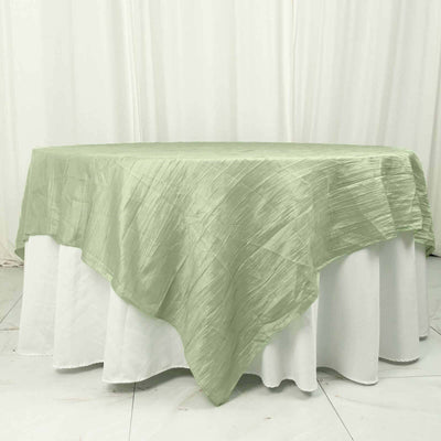 Green tablecloth draped elegantly over a white table.