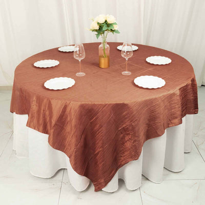 Round brown tablecloth on a dining table set with plates and glasses.