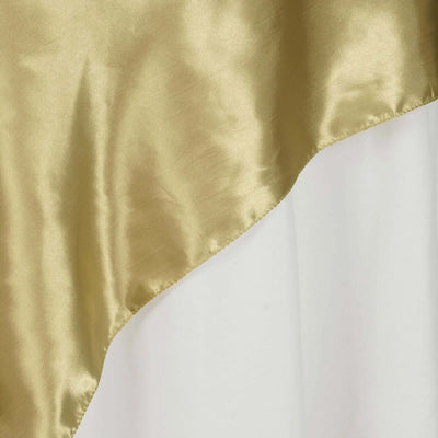 Gold satin fabric draped elegantly, showcasing a smooth texture.