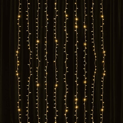 String lights hanging vertically against a dark backdrop.