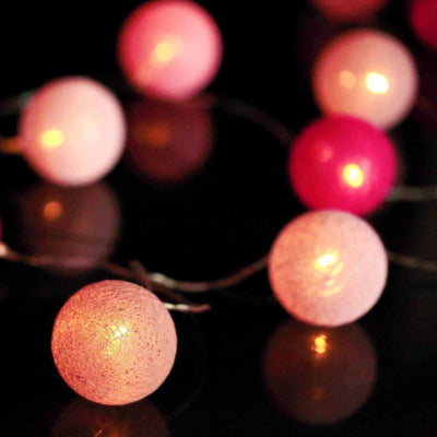 Pink and red decorative string lights glowing softly.