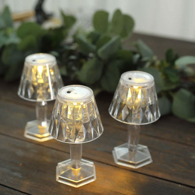 Elegant crystal table lamps with warm LED lights illuminating a rustic wooden table.