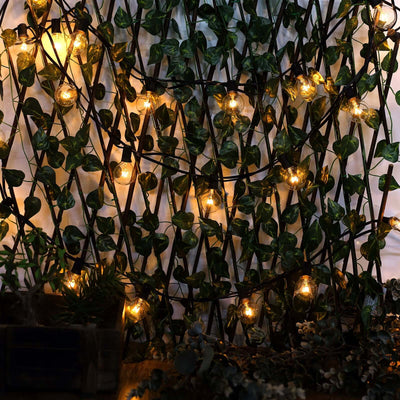 String lights entwined in greenery for a cozy ambiance.