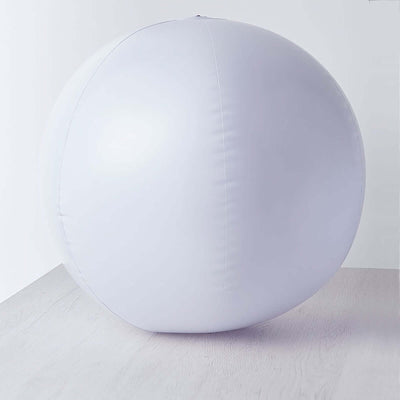 White inflatable exercise ball on a plain white background