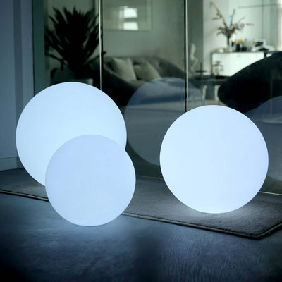 Three illuminated round lamps in a modern interior setting.