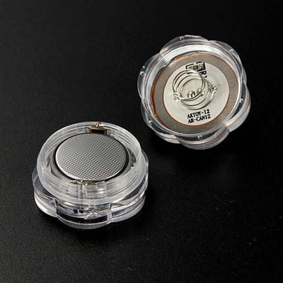 Clear flower-shaped battery holder with a metallic button cell inside.