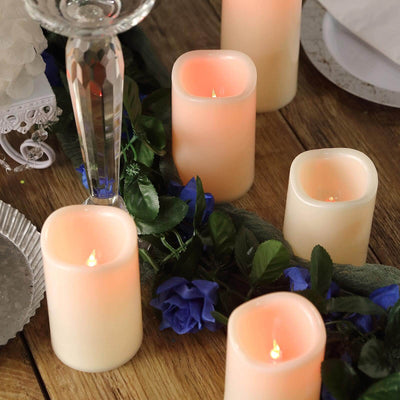 Set of LED candles surrounded by flowers and decorative elements.