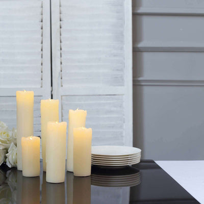 Set of six flameless LED candles on a sleek black table.