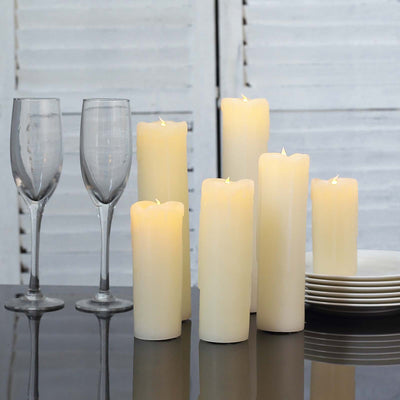 LED flameless candles in varying heights with champagne glasses and plates.