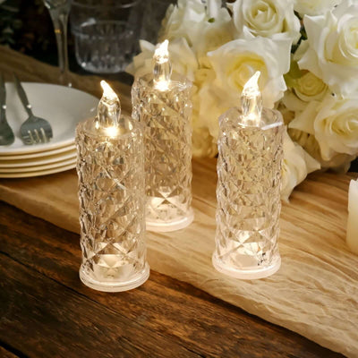 Elegant crystal candle holders with LED flames on a dining table.