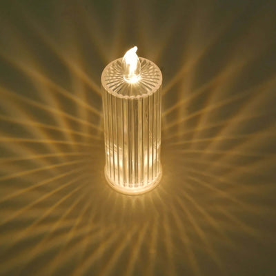 LED candle with a flickering flame effect, casting warm light and shadows.