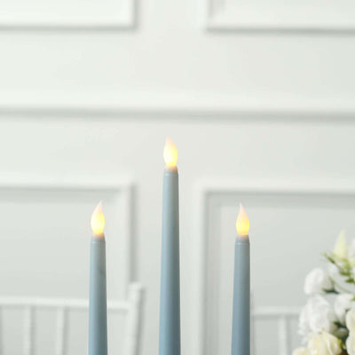 Blue taper candles with realistic flames on a white background.