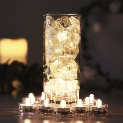 LED lights in a glass vase filled with ice cubes, creating a warm glow.