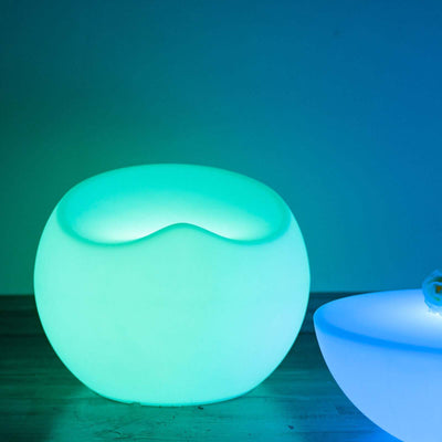 Illuminated modern seating in soothing blue and green tones.