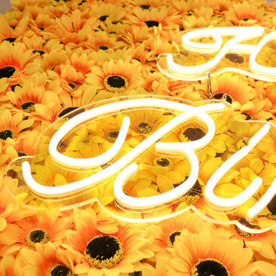 Neon sign on a vibrant sunflower backdrop.