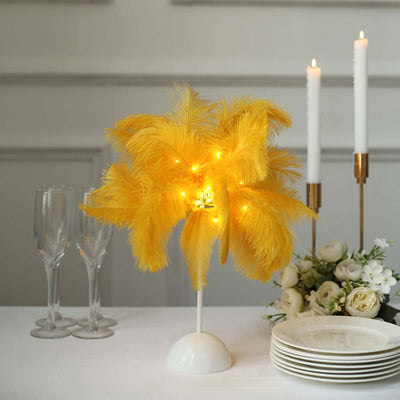 Yellow feather decorative lamp with lights on a dining table.