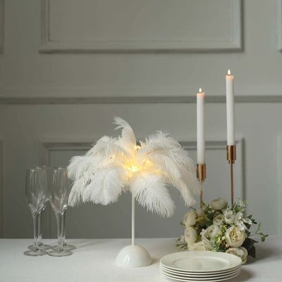 Feather table lamp with warm lights and elegant decor elements on a table setting.