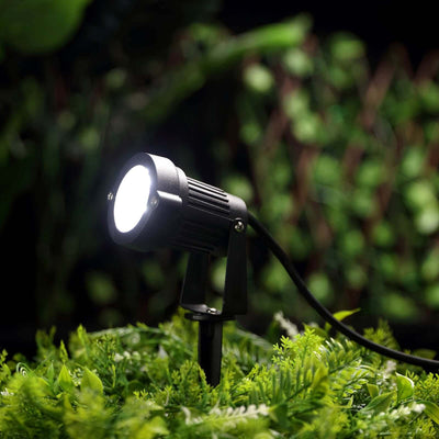 Outdoor LED spotlight with adjustable angle for garden lighting.