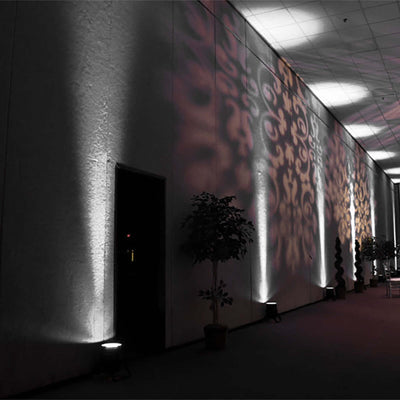 Decorative lighting patterns on walls in an indoor space.